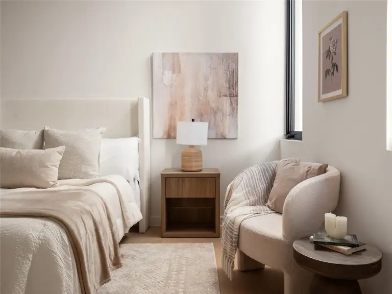 A well-lit primary bedroom offers a serene retreat with a cozy reading nook. A well-lit primary bedroom offers a serene retreat with a cozy reading nook.