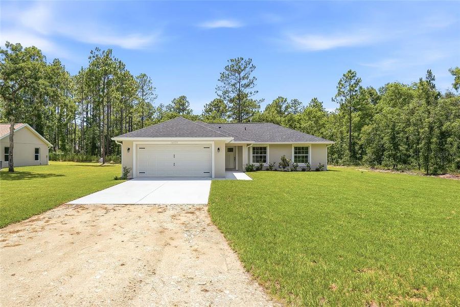 Front exterior of a new home in , Weeki Wachee, FL, highlighting curb appeal (Image 25). Front exterior of a new home in , Weeki Wachee, FL, highlighting curb appeal (Image 25).