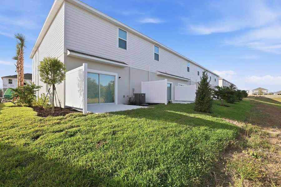 Exterior details and patio area of a home in The Towns at Firethorn, Parrish (Image 31).