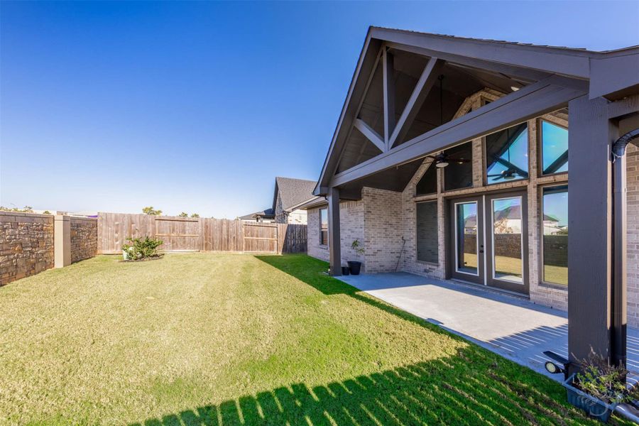 The large, fully fenced backyard offers plenty of room for play, pets, or future outdoor enhancements. With the home’s striking gabled patio and expansive windows as a backdrop, this space is ideal for entertaining or unwinding in privacy. The large, fully fenced backyard offers plenty of room for play, pets, or future outdoor enhancements. With the home’s striking gabled patio and expansive windows as a backdrop, this space is ideal for entertaining or unwinding in privacy.