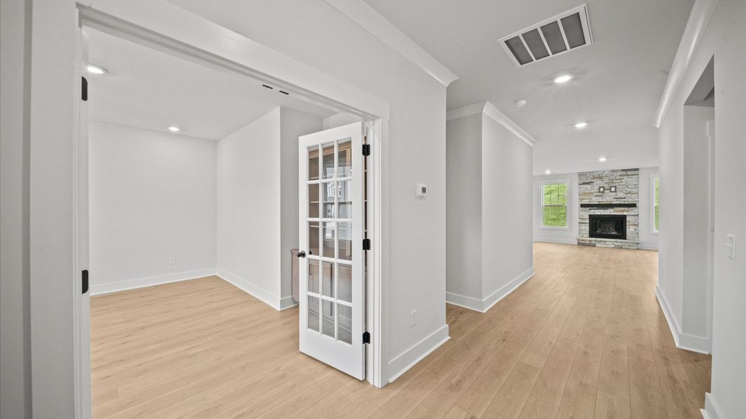 Elegant foyer with hardwood flooring and tasteful trim detail creates a memorable first impression