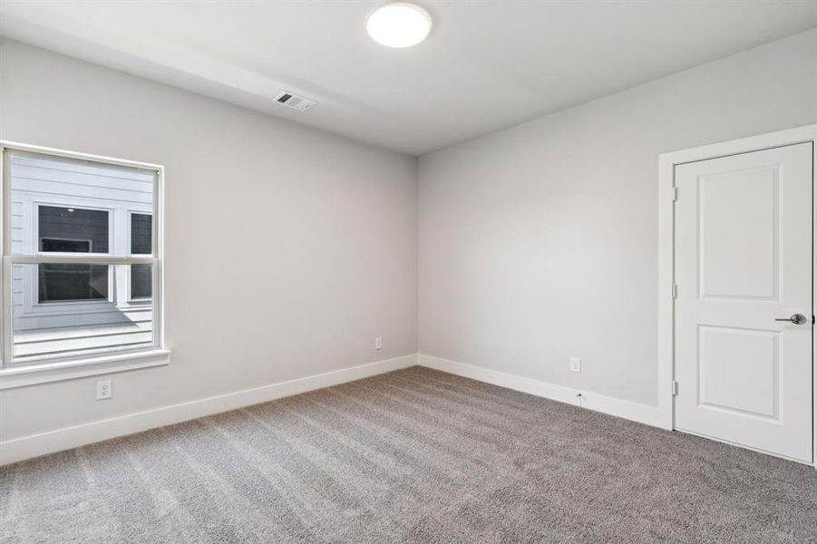 Spare room featuring baseboards and carpet flooring Spare room featuring baseboards and carpet flooring