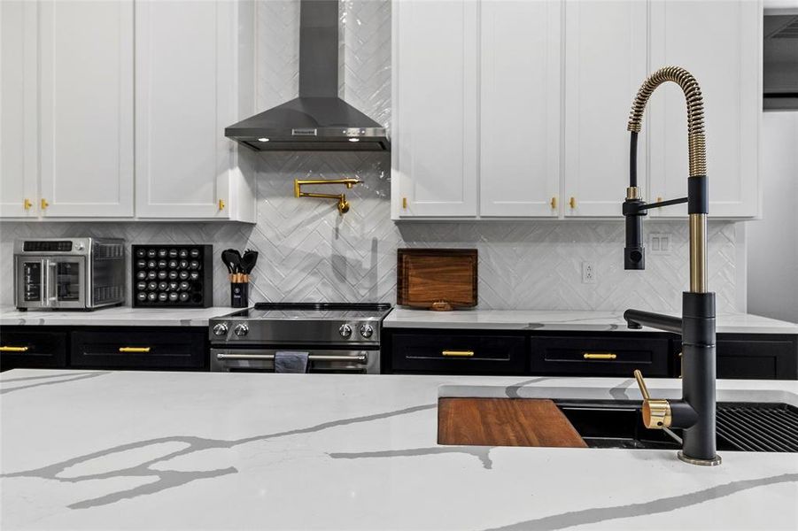 Zoom in to see the exquisite herringbone tile backsplash