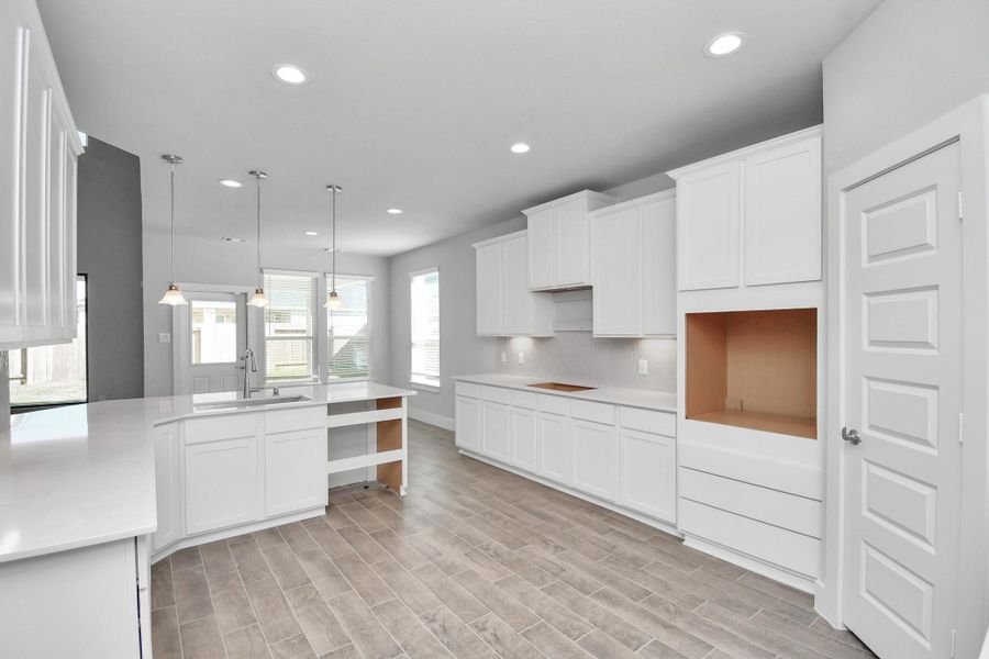 The extended counter area adds both practicality and style, making meal preparation a breeze. Every detail is thoughtfully designed to enhance the kitchen's functionality and aesthetic appeal.