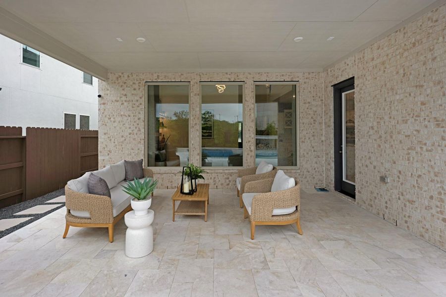Covered patio with travertine and lots of space.