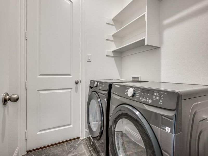 Clothes washing area featuring laundry area and separate washer and dryer