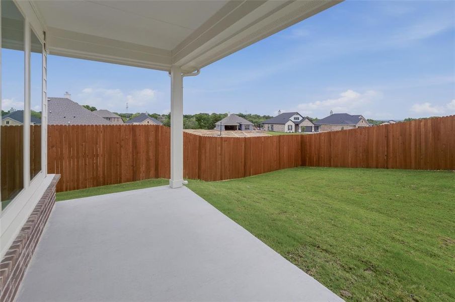 Covered patio featuring a concrete slab and white support columns