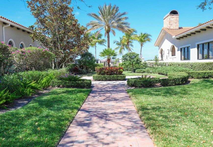 Front exterior of a new home in PGA Village Verano, Port St. Lucie, FL, highlighting curb appeal (Image 29).