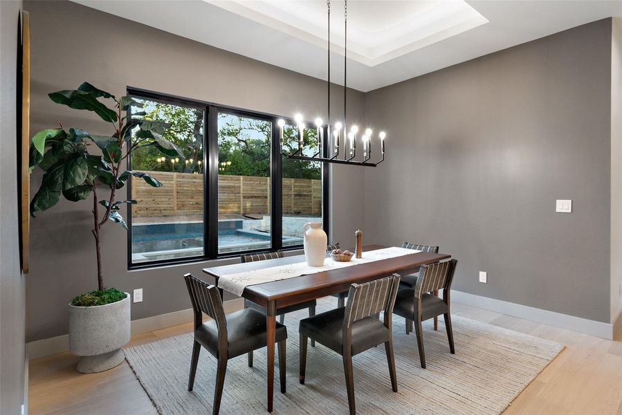 Tray ceilings with accent lighting hover over the dining room.