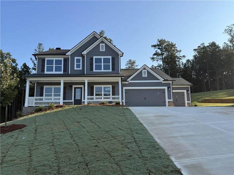Front exterior of a new home in Woodland Hills, Loganville, GA, highlighting curb appeal (Image 1). Front exterior of a new home in Woodland Hills, Loganville, GA, highlighting curb appeal (Image 1).