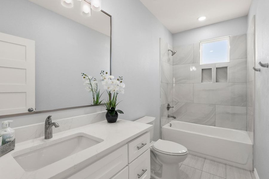 Full bath with vanity, bathtub / shower combination, and tile patterned flooring Full bath with vanity, bathtub / shower combination, and tile patterned flooring