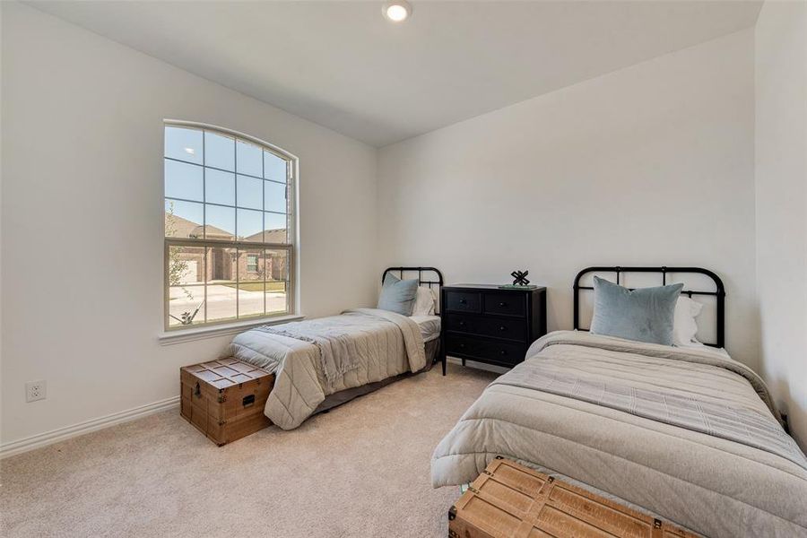 Bedroom featuring light colored carpet