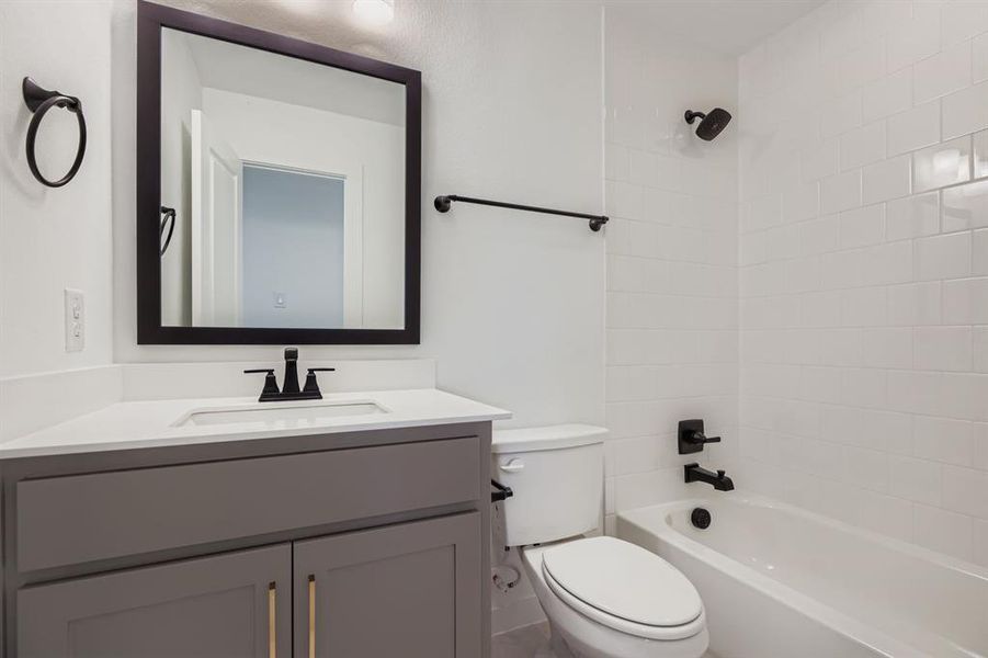 Bathroom featuring bathtub / shower combination and vanity