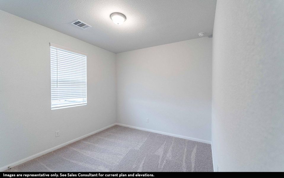 Unfurnished room featuring light carpet and a textured ceiling