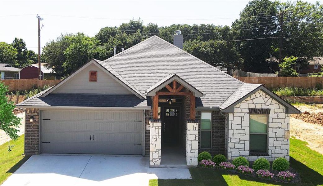 View of front of house with a front yard and a garage