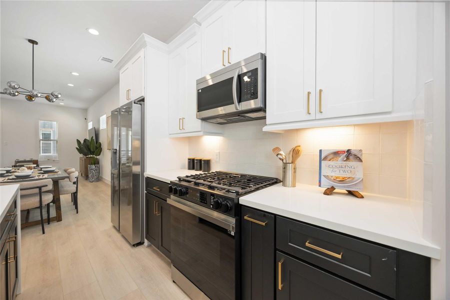 Island kitchen. Photo of the model home. Finishes & specifications may vary.