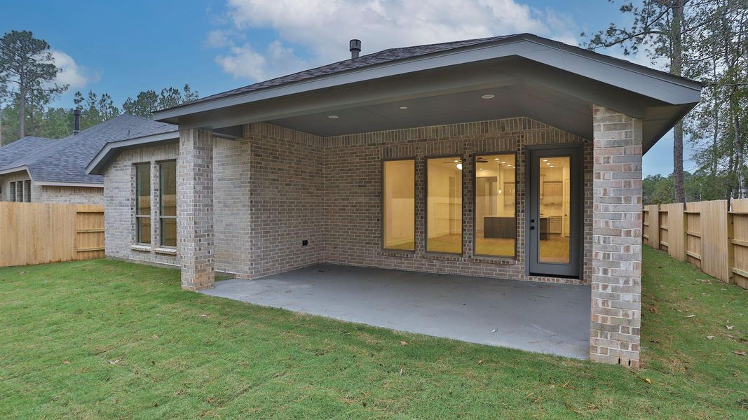 Exterior details and patio area of a home in Woodhavyn 50', Magnolia (Image 2).