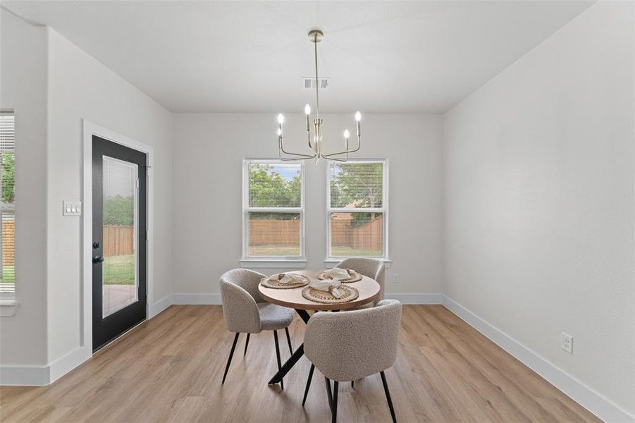 Dining room featuring light wood-style flooring and healthy amount of natural light Dining room featuring light wood-style flooring and healthy amount of natural light