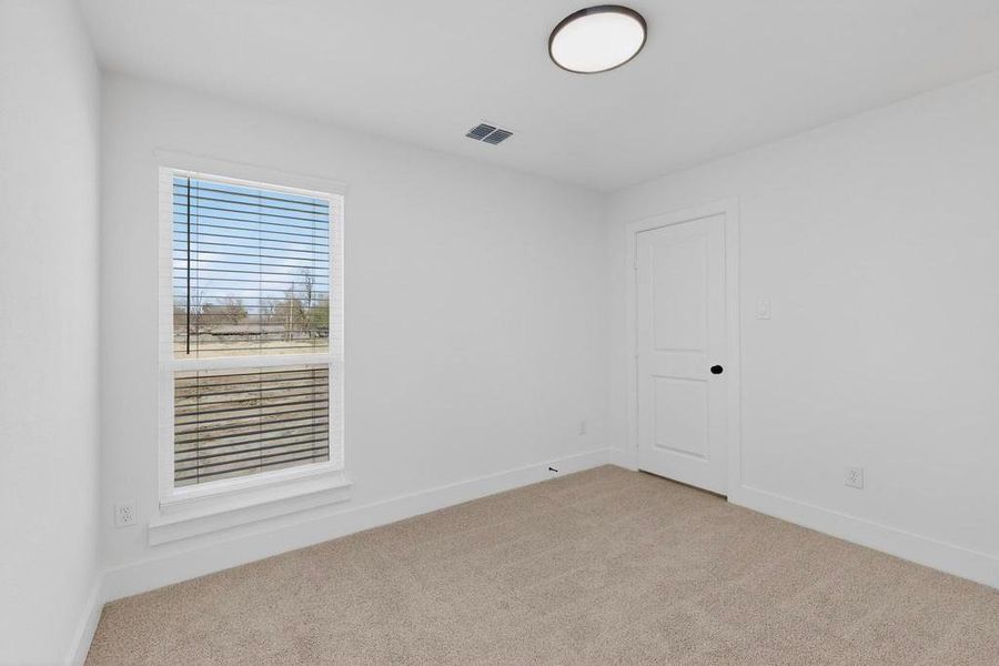 Unfurnished room featuring baseboards and light colored carpet