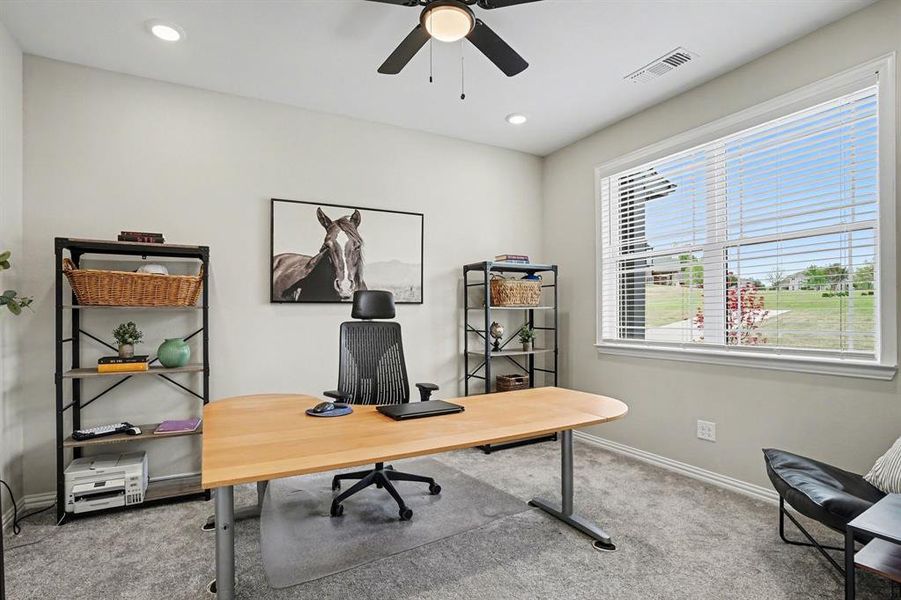 Office space featuring light colored carpet, ceiling fan, and recessed lighting