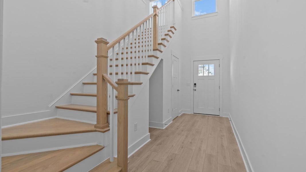Exceptional foyer with warm hardwood flooring and refined finishes throughout