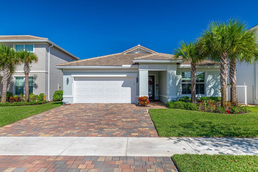 Front exterior of a new home in Windsong Estates, Lake Worth, FL, highlighting curb appeal (Image 24).