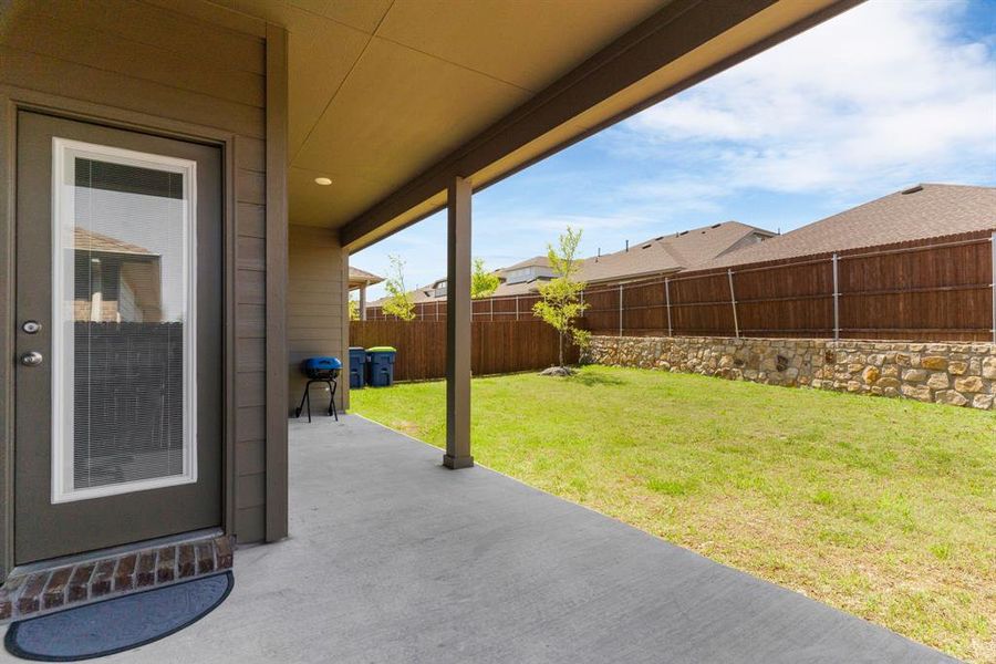 View of patio featuring fence
