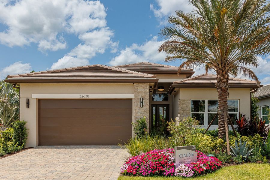 Representative exterior photo of a completed home built from the Claudia by GL Homes in Valencia Ridge, Wesley Chapel, FL (Image 1). Representative exterior photo of a completed home built from the Claudia by GL Homes in Valencia Ridge, Wesley Chapel, FL (Image 1).