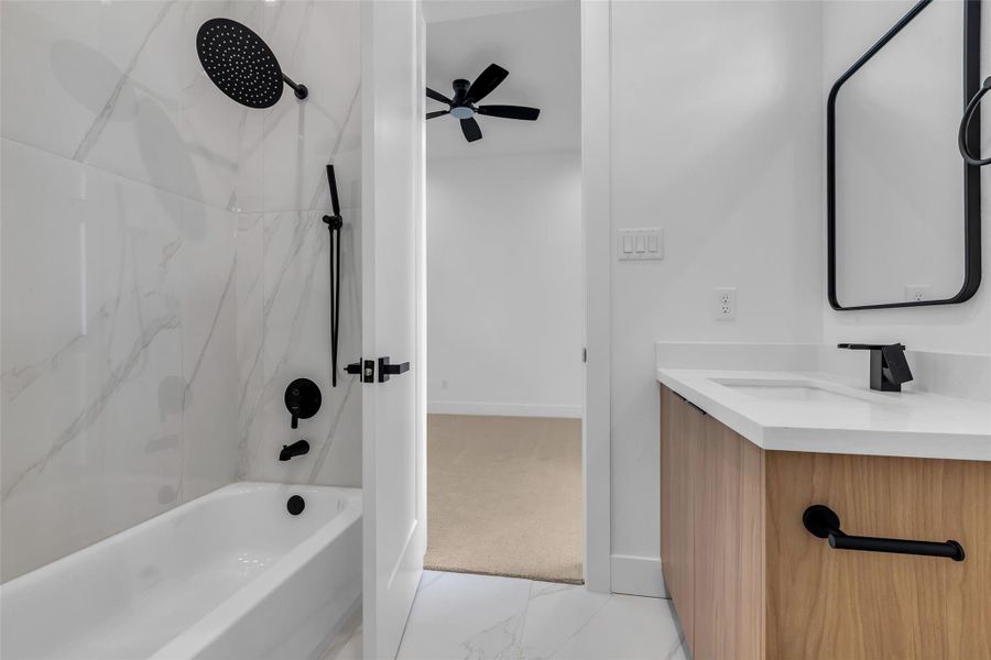 The en-suite bathroom includes a tub and shower combination, providing versatility for both relaxing baths and quick showers. The en-suite bathroom includes a tub and shower combination, providing versatility for both relaxing baths and quick showers.