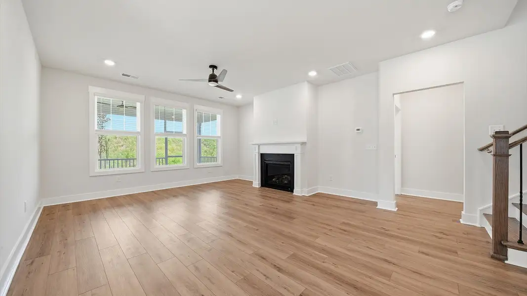 Spacious family room with rich hardwood flooring and elegant trim work in a reputable DRB Homes build