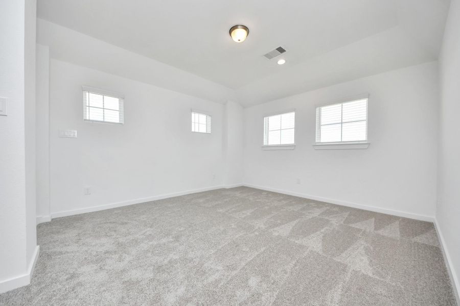 Come upstairs and enjoy a day of leisure in this fabulous game room! This is the perfect hangout spot or adult game room! Features plush carpet, high ceilings, custom paint and windows for plenty of natural light.