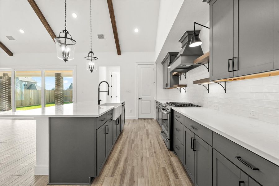 Chef-worthy kitchen with grey cabinets and quartz counters (*Photo not of actual home and used for illustration purposes only.)