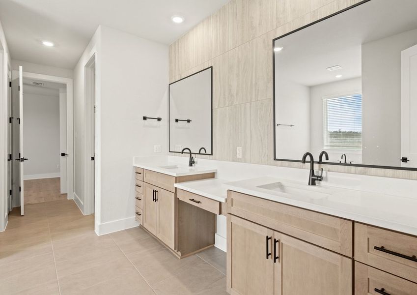 The master bathroom has a dual-sink vanity with a makeup station in between.