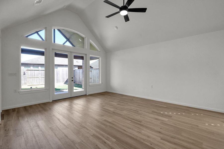 The family room has French doors and large windows leading to the covered back patio.