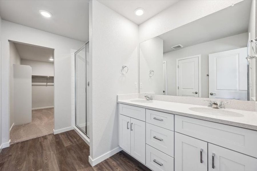 A bathroom with white cabinets. A bathroom with white cabinets.