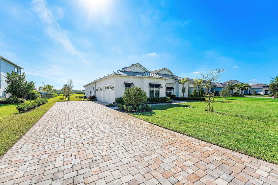 Front exterior of a new home in Bridgewater, Jupiter, FL, highlighting curb appeal (Image 1). Front exterior of a new home in Bridgewater, Jupiter, FL, highlighting curb appeal (Image 1).