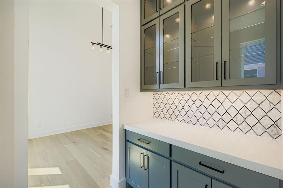 Bathroom featuring backsplash and light wood-style floors Bathroom featuring backsplash and light wood-style floors