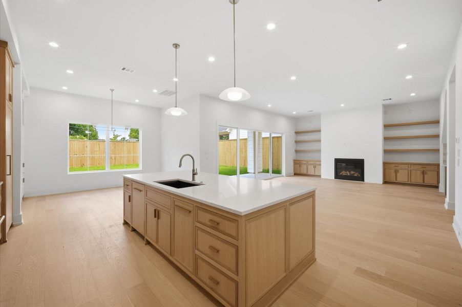 Spacious living area features custom white oak built-in cabinetry and abundant natural light.