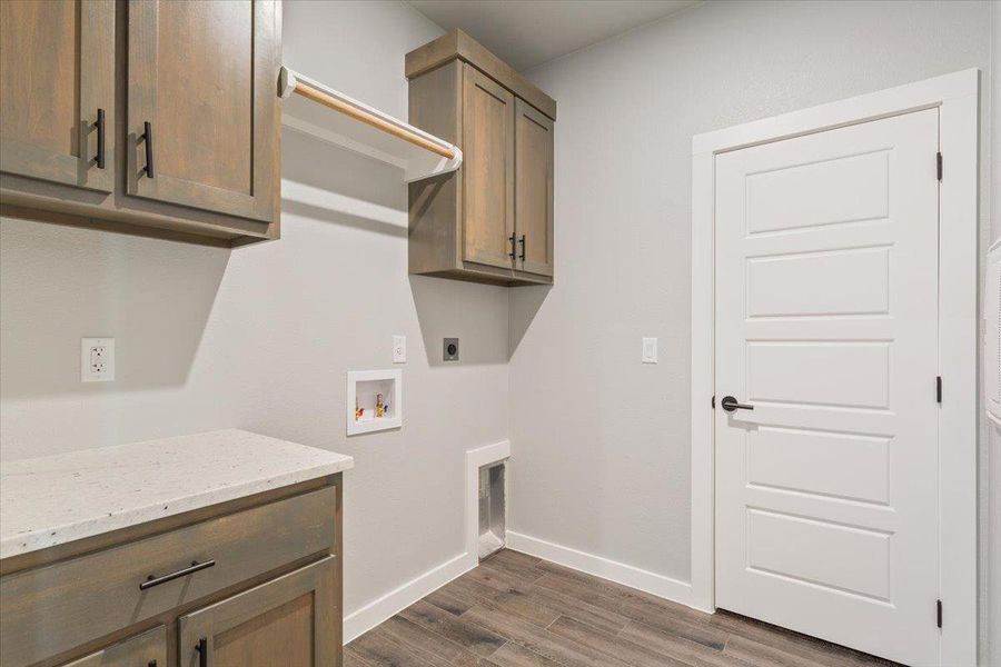 Laundry room featuring cabinet space, dark wood finished floors, electric dryer hookup, and washer hookup