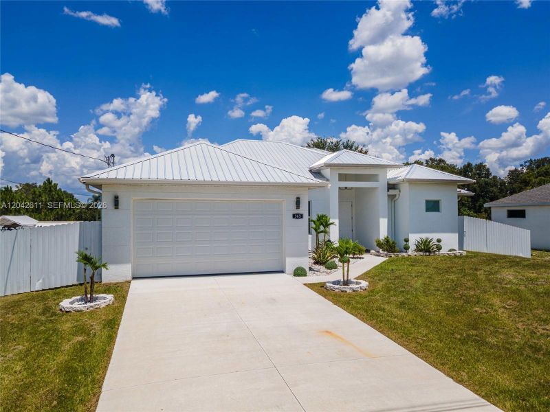 Front exterior of a new home in , Lehigh Acres, FL, highlighting curb appeal (Image 27).