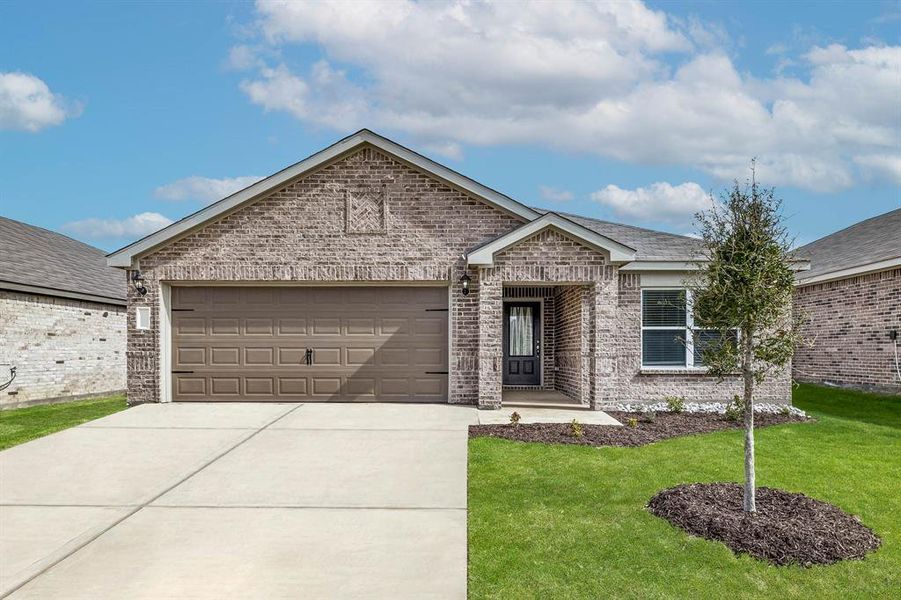 View of front of home with a garage and a front yard