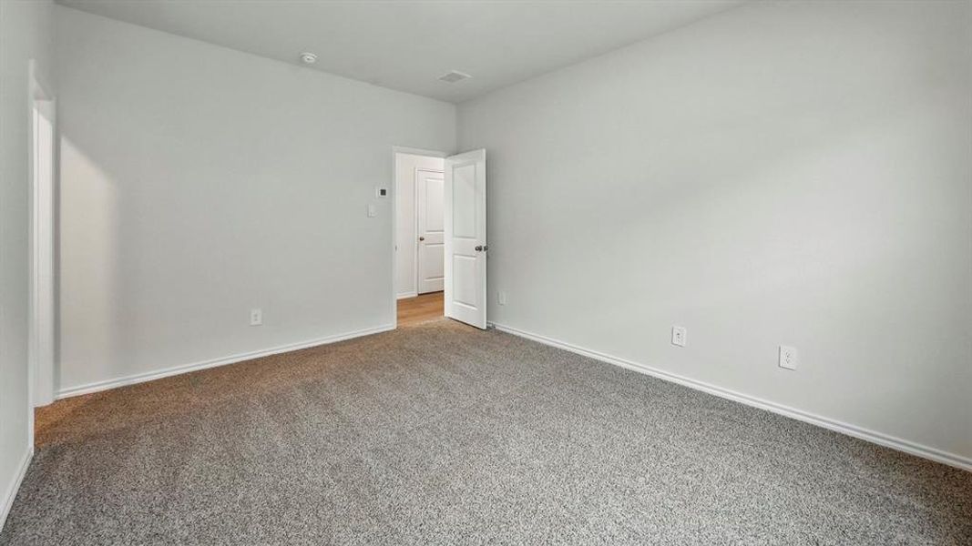 Carpeted empty room featuring baseboards