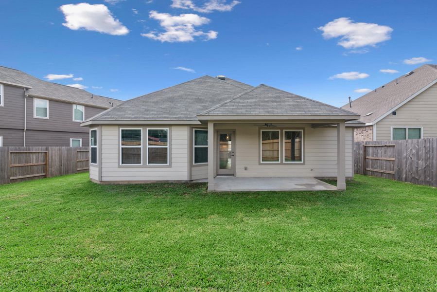 Exterior details and patio area of a home in Pinewood at Grand Texas, New Caney (Image 13).