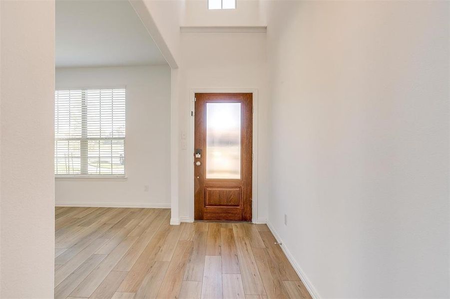 Entrance foyer with light wood-type flooring