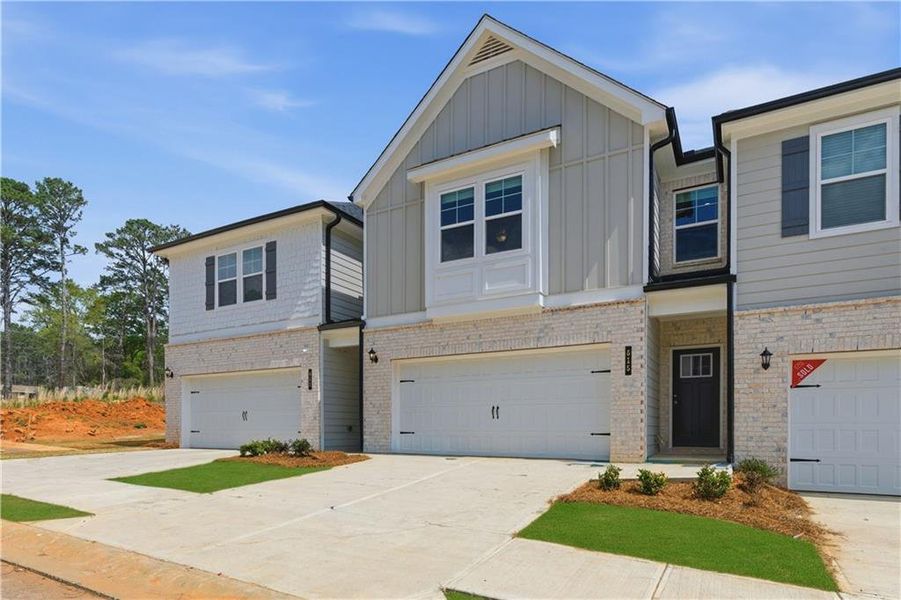 Front exterior of a new home in Diamante, Stockbridge, GA, highlighting curb appeal (Image 24). Front exterior of a new home in Diamante, Stockbridge, GA, highlighting curb appeal (Image 24).
