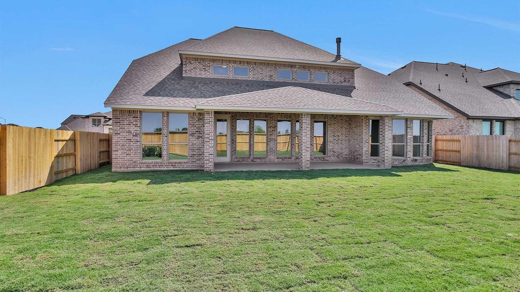 Front exterior of a new home in Elyson 65', Katy, TX, highlighting curb appeal (Image 1). Front exterior of a new home in Elyson 65', Katy, TX, highlighting curb appeal (Image 1).