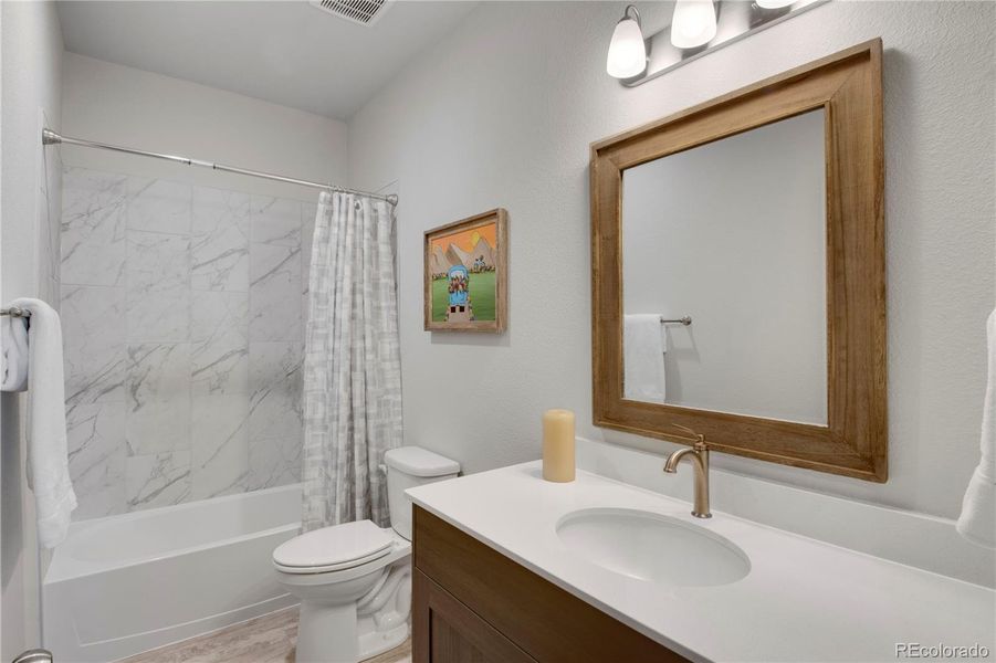 Bedroom #2 featuring light carpet and natural light