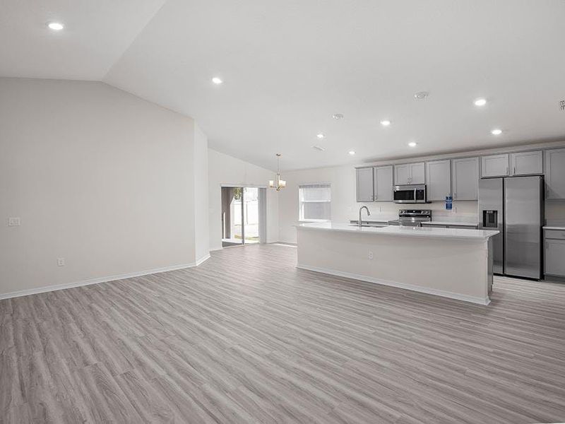 Inside, this beautiful home features a sunny, open living area with volume ceilings and low-maintenance LVP flooring. Inside, this beautiful home features a sunny, open living area with volume ceilings and low-maintenance LVP flooring.