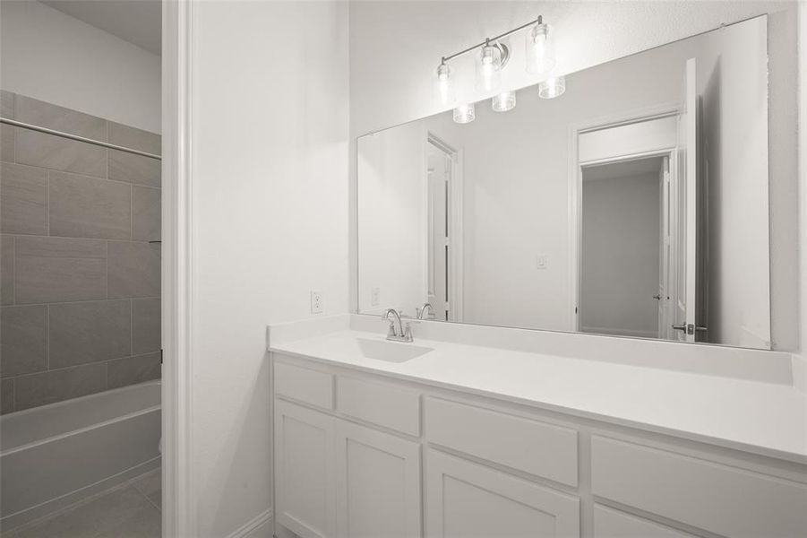 Full bathroom featuring vanity, shower / tub combination, and tile patterned flooring Full bathroom featuring vanity, shower / tub combination, and tile patterned flooring