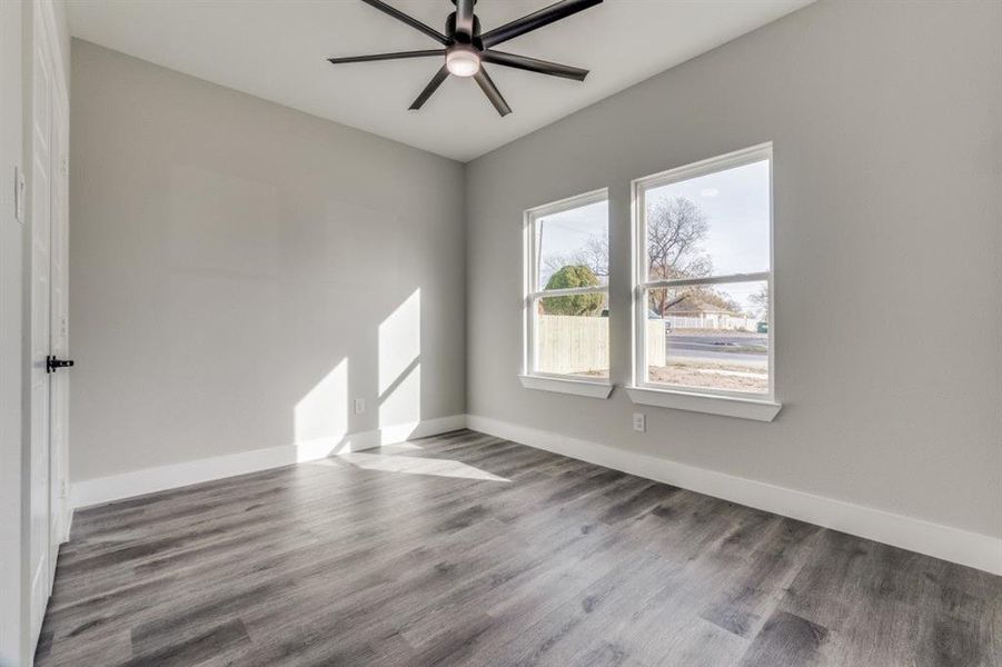 Empty room with wood-type flooring and ceiling fan